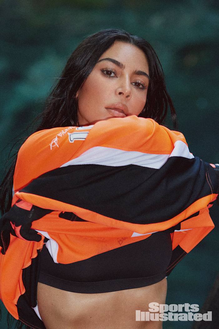 Kim Kardashian was photographed by Greg Swales in the Dominican Republic. Swimsuit by SKIMS. Top by Balenciaga. Gloves by Fox.